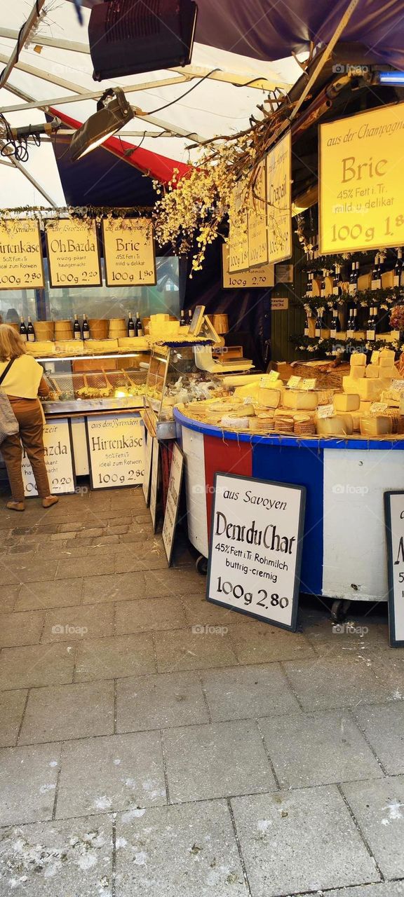 This is a gourmet supermarket in the city of “Munich”, the capitol of “Bavaria”. All sorts of exquisite cheeses are being offered here. 2023. Hypnotic Productions