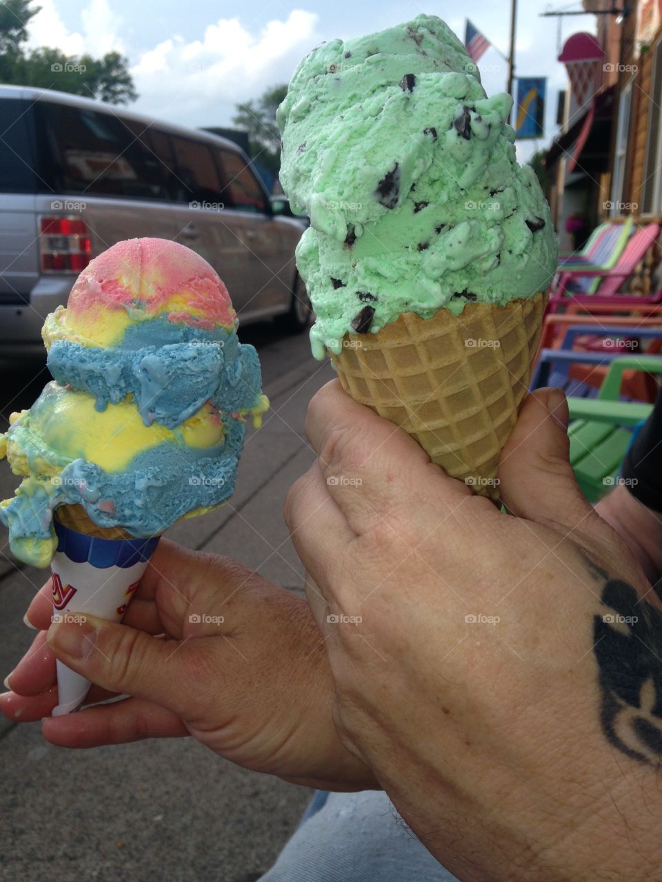 Two ice cream cones in  hands. Cones of ice cream, on a summer evening!