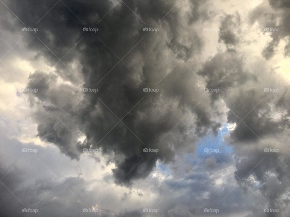 Thunder clouds forming in the blue sky 