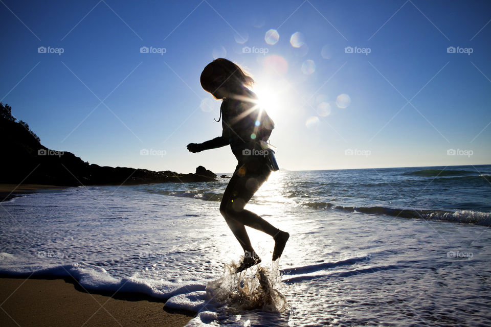Girl silhouette, leap, jump, sand, sea, shore, sun rays, free