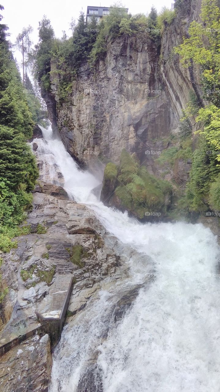 Bad Gastein, Austria, waterfall cascade at city, rock mountain, rock hill, river cascade