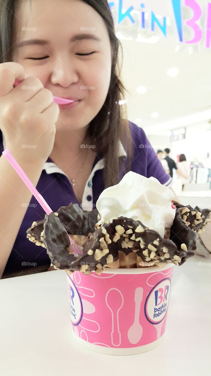 Asian woman eating ice-cream