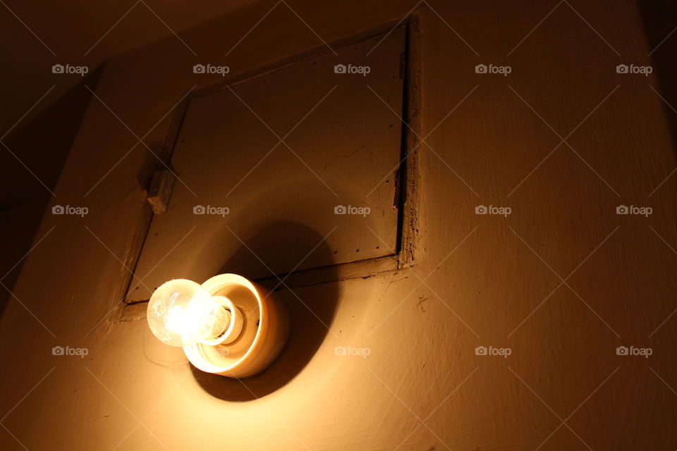 light bulb in dark room and wooden door