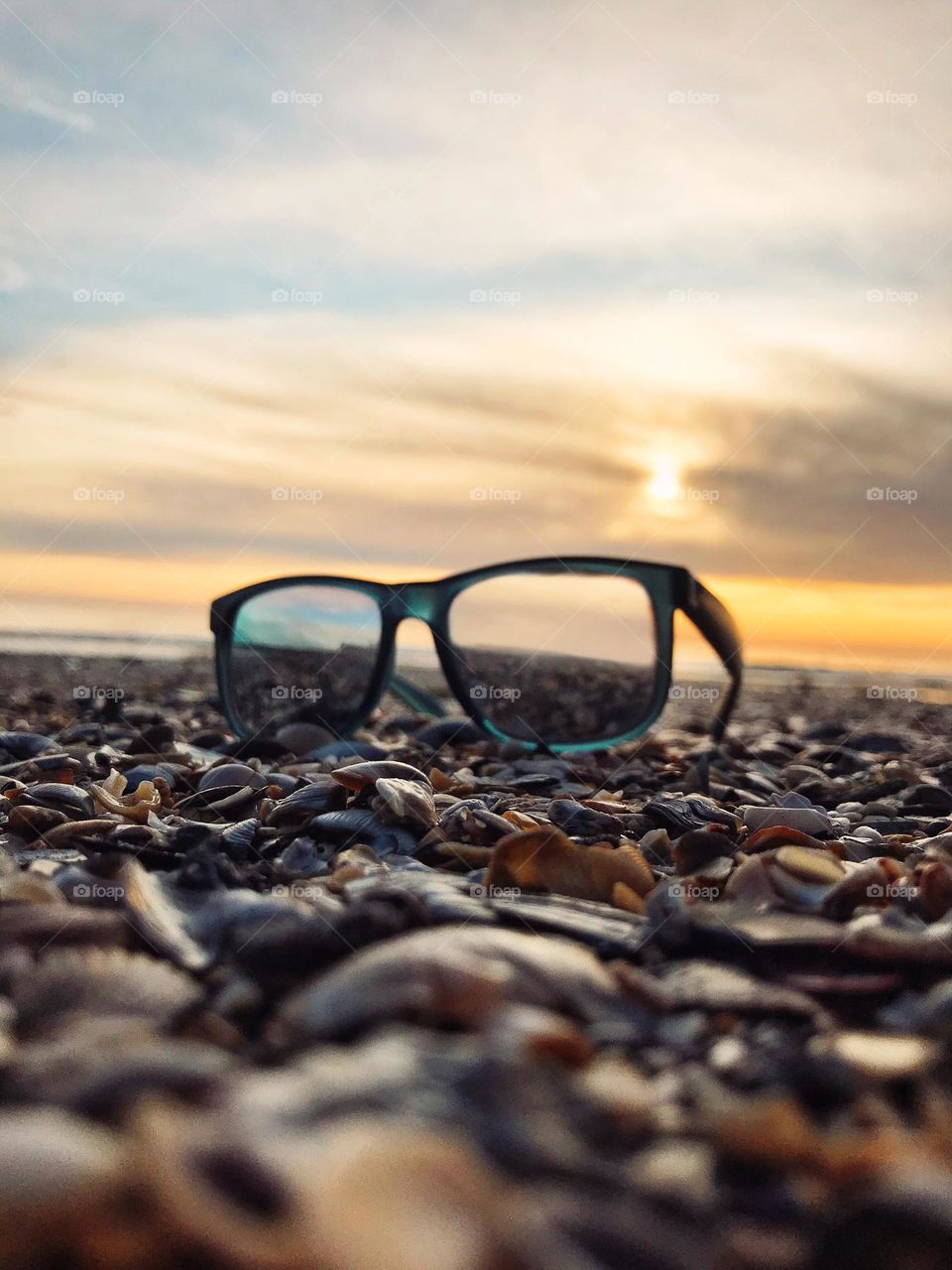 Ground up photo of the glasses at the beach at the sunset light close up