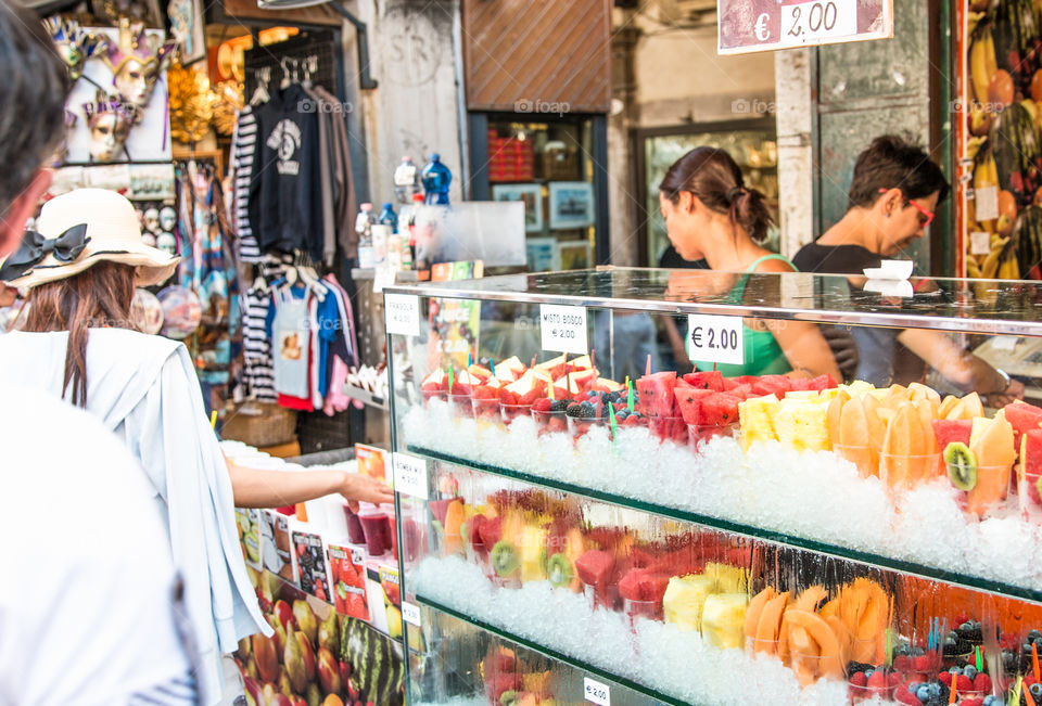 Saleswoman In A Fruits Shop Serves Customer
