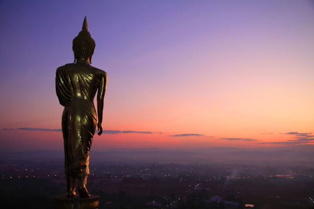 Behind the buddha statue in sunrise time