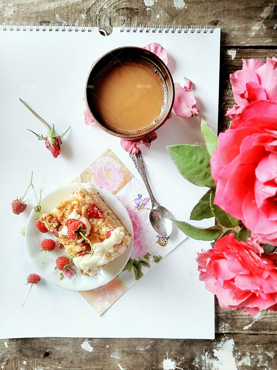delicate creamy raspberry cake, coffee and a bouquet of roses