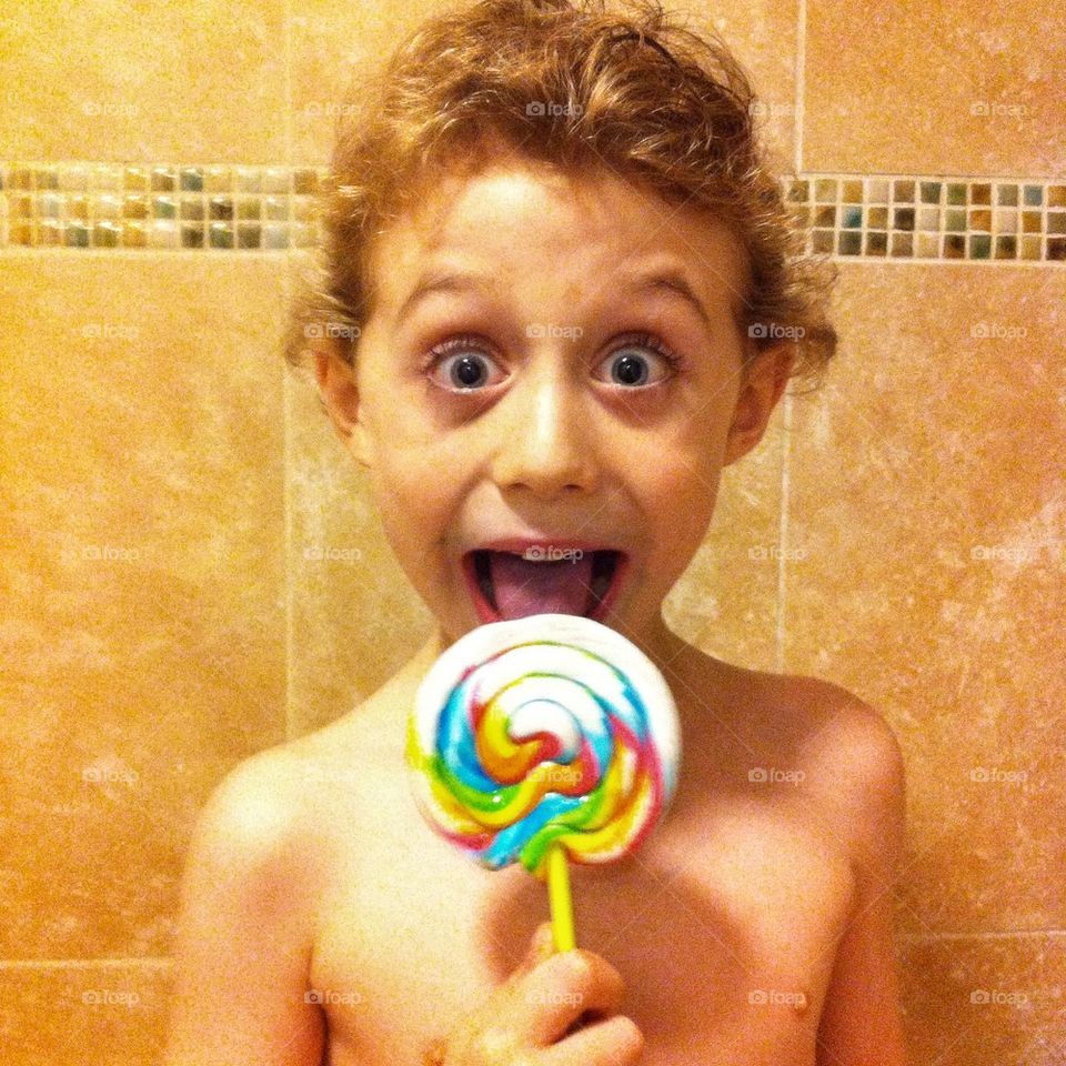Boy licking a lollypop