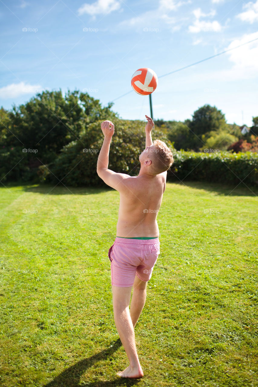 Man playing with a ball in the sun