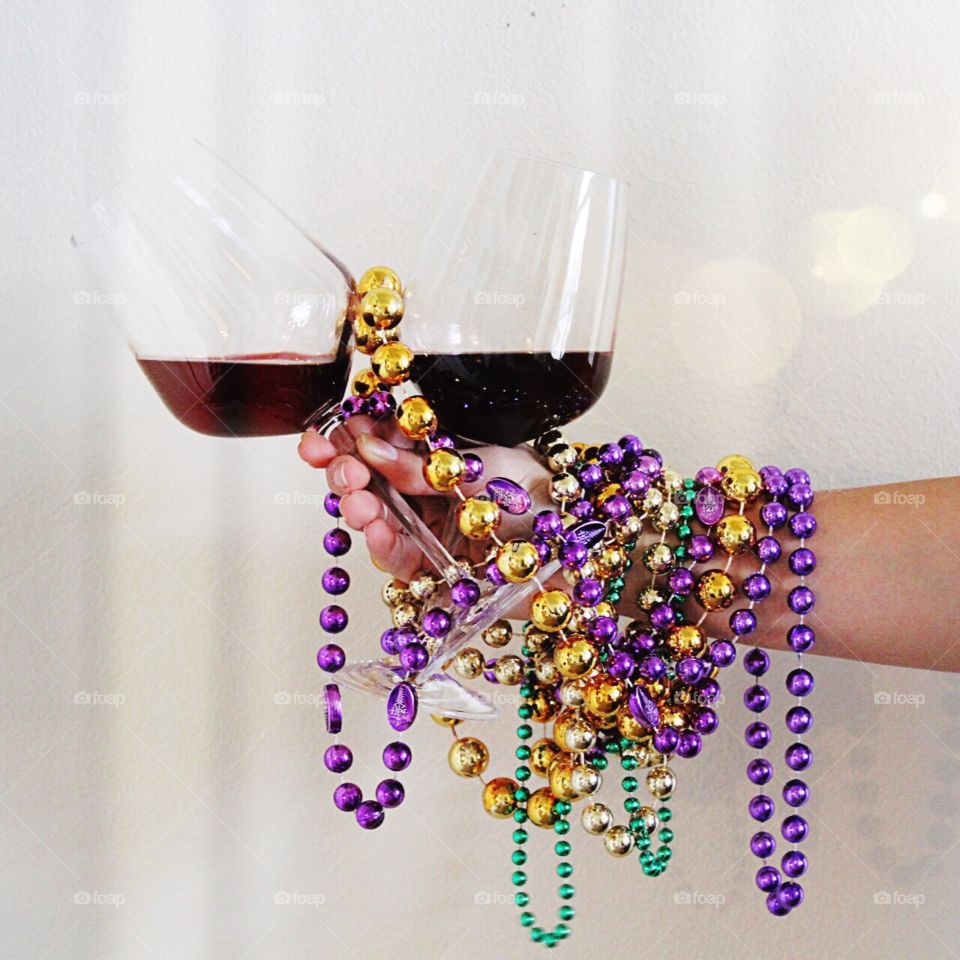 Celebrating Mardi Gras with red wine and beads!