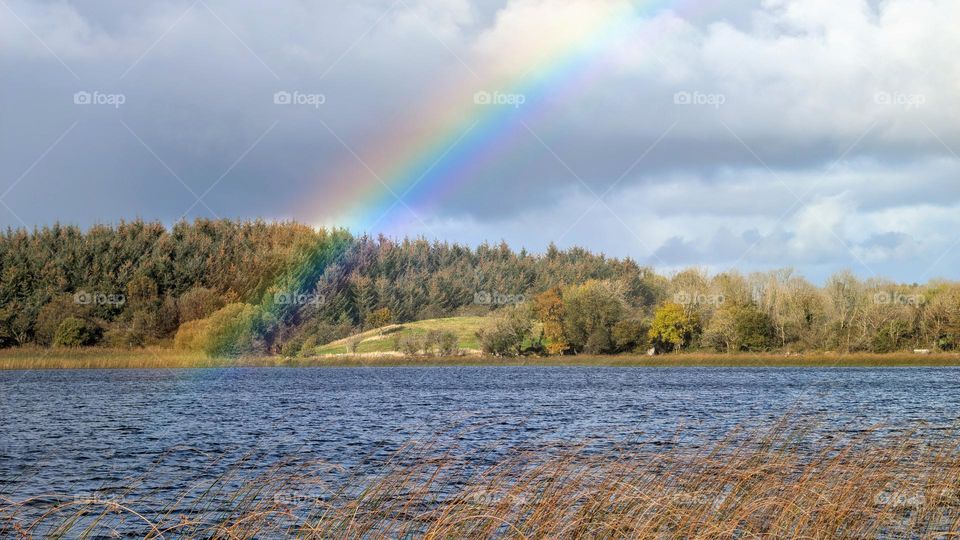 Autumn lakeside landscape scenery, rainbow over Ballyquirke Lough, Moycullen, galway, Ireland