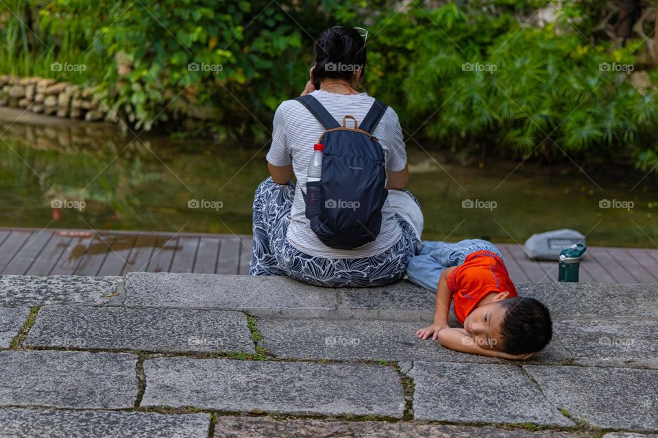 an upset  kid is laying down