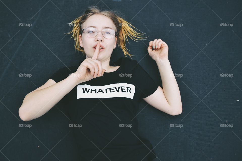 Husch keep quiet - teenage girl wearing a top with the text ”whatever”