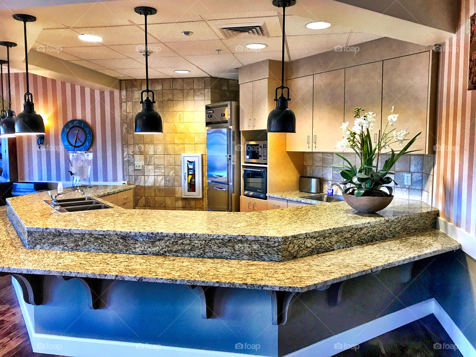 Well lit kitchen with predominant areas of blue and yellow