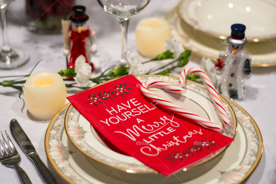 Christmas dinner is a classic tradition with candy canes, snowmen name cards, candles & flowers perfect dishes & table center piece for festive seasonal dinner 