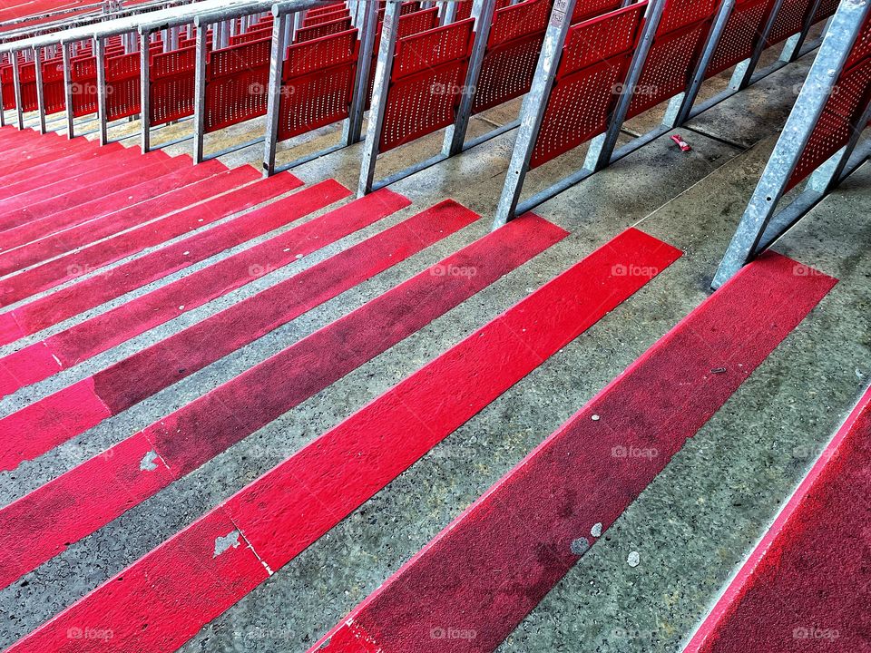 Red steps and red seats in an empty stadium