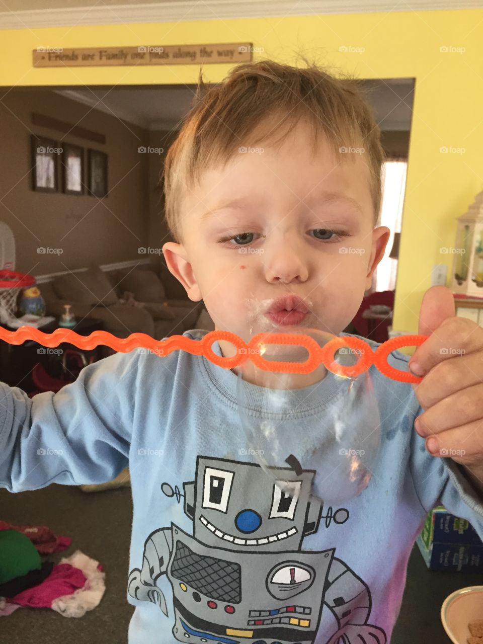 Cute boy blowing bubbles