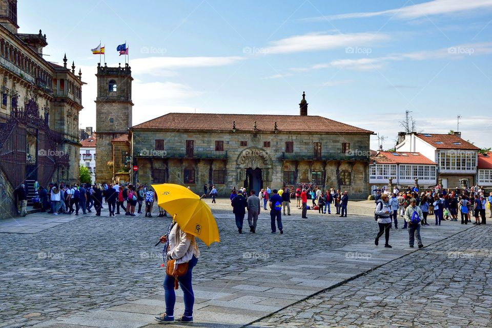Pilgrims and tourists at Plaza del Obradoiro, Santiago de Compostela, Spain.