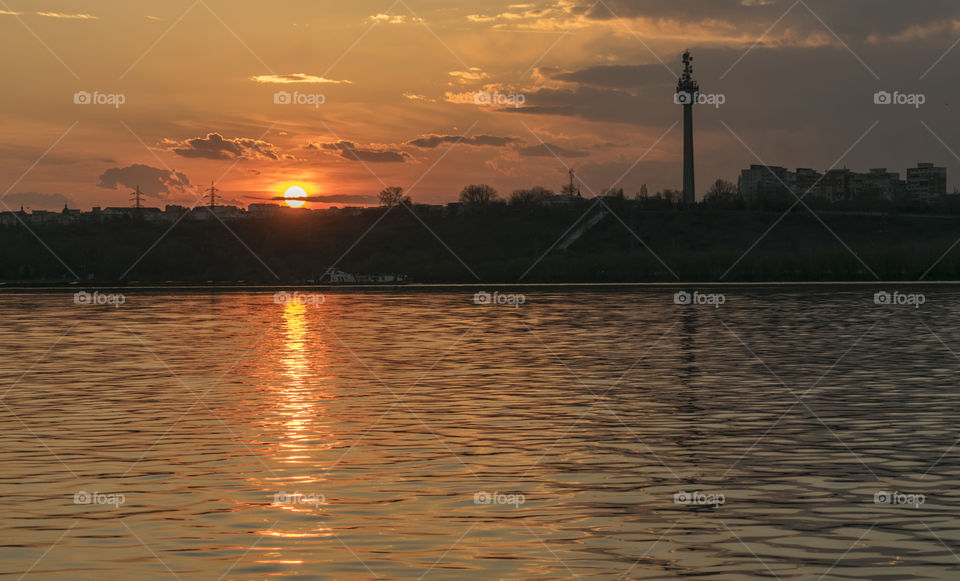 Beautiful sunset on town.Sunset water reflection