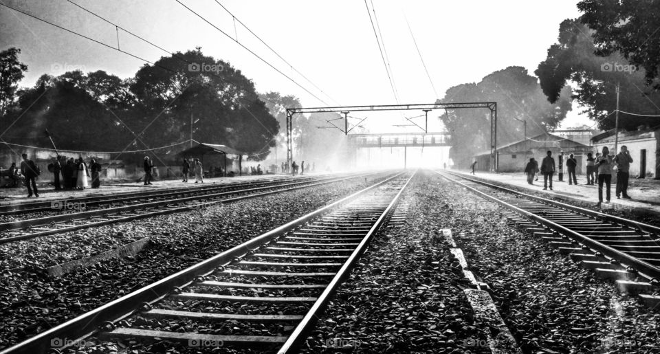 Picture taken at a small railway station of India. During the starting of the winter season signified by the fog visible on the track.
