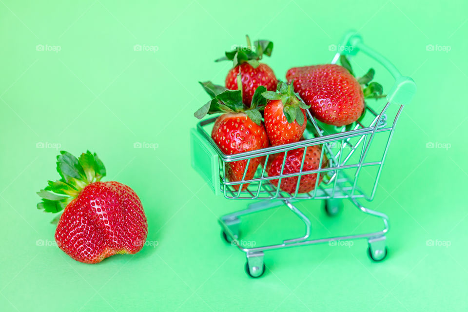 Fresh organic strawberries on a green background