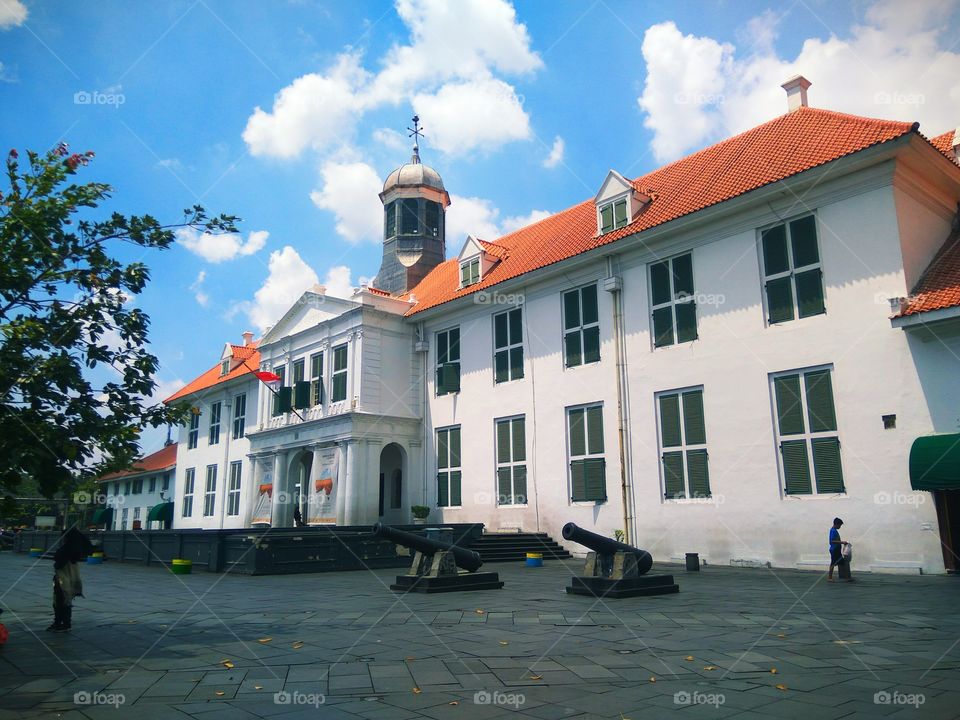 this is museum old building with nice blue sky  and some Canon in front