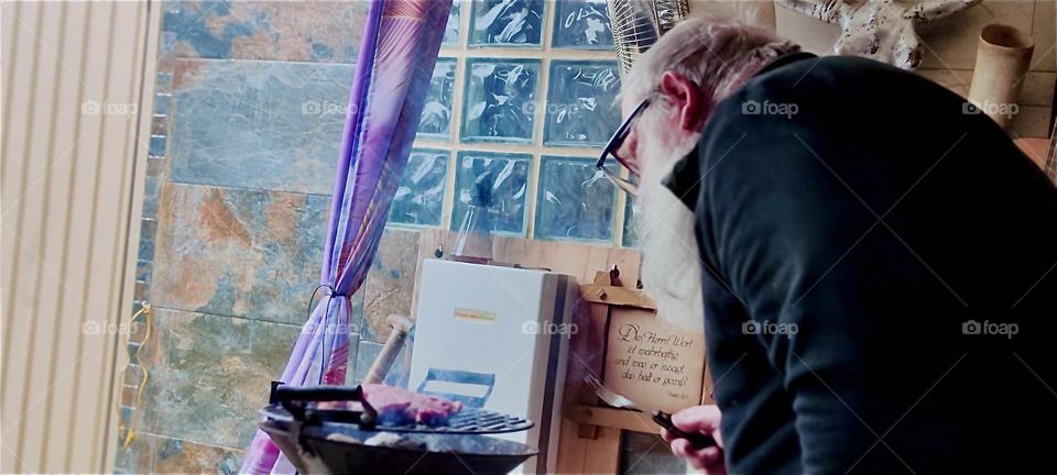 Barbecuing takes patience and proper timing to get the meat cooked just right such as is practiced here at „Ron‘s Whiskey Lounge“ in rural „Bavaria“, Germany. 2024. Hypnotic Productions