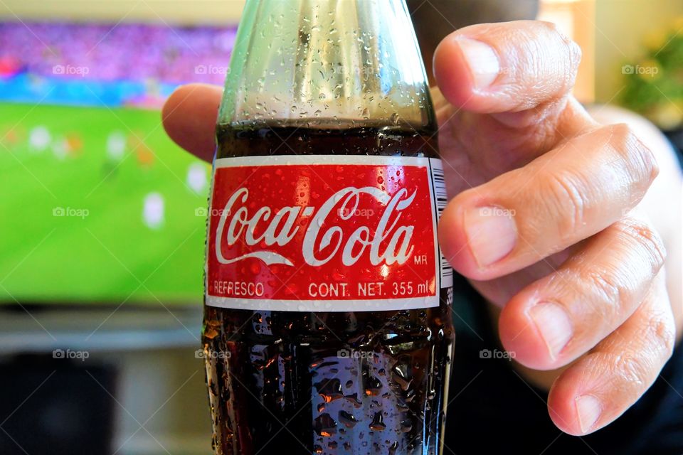 Enjoying football with Coke