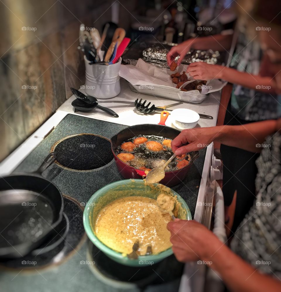 Women cooking tikka in kitchen