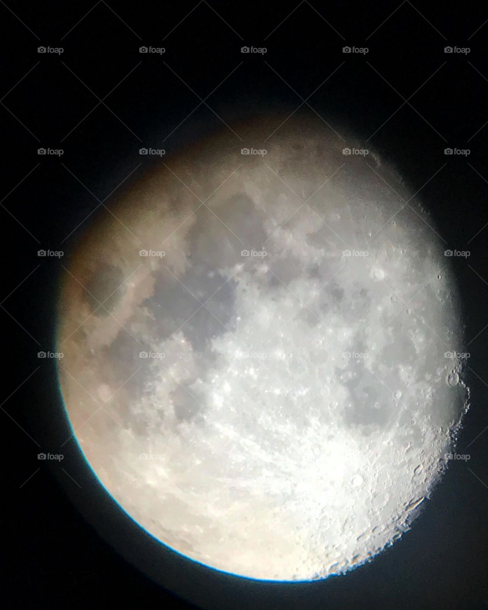 The moon and craters visible through the telescope 