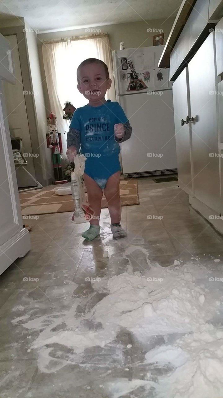 The terrible two's starting already . My grandson got into the cupboard and found the bag of flour