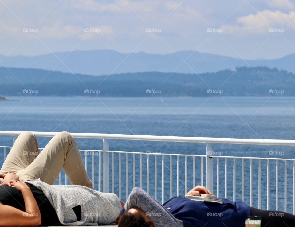 People relaxing on the BC ferry on its way from
Vancouver Island to Vancouver. Sunshine Coast and mountains 