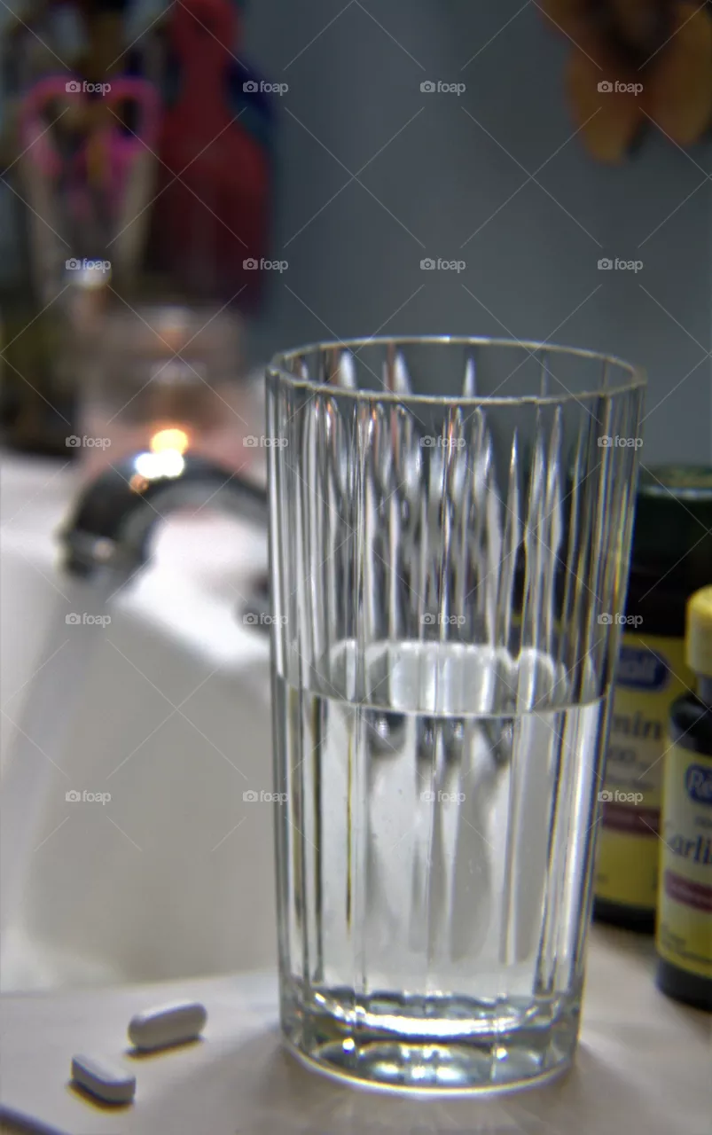Vitamin Supplements With a Glass of Water