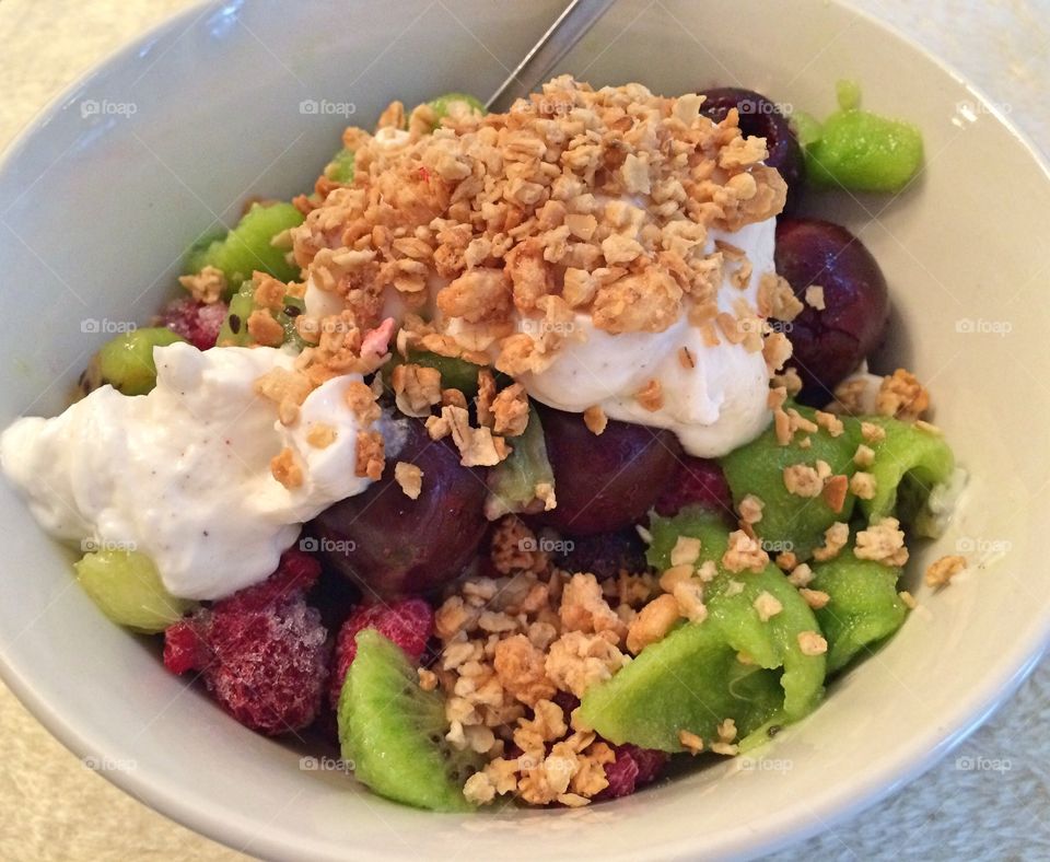 Fruits and berries with granola and vanilla greek yogurt 