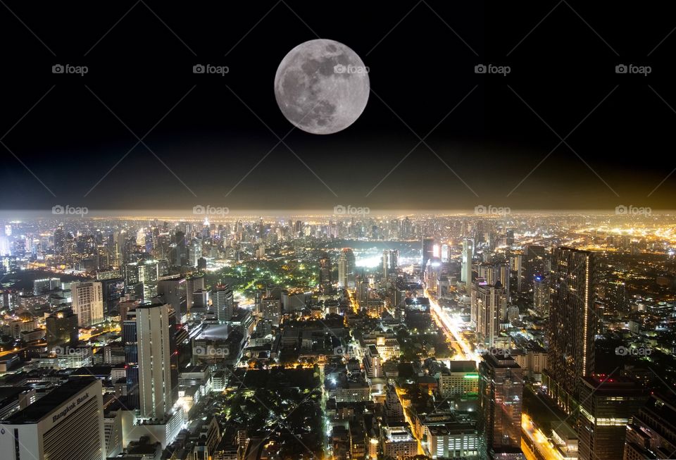 Full moon over central city Bangkok Thailand