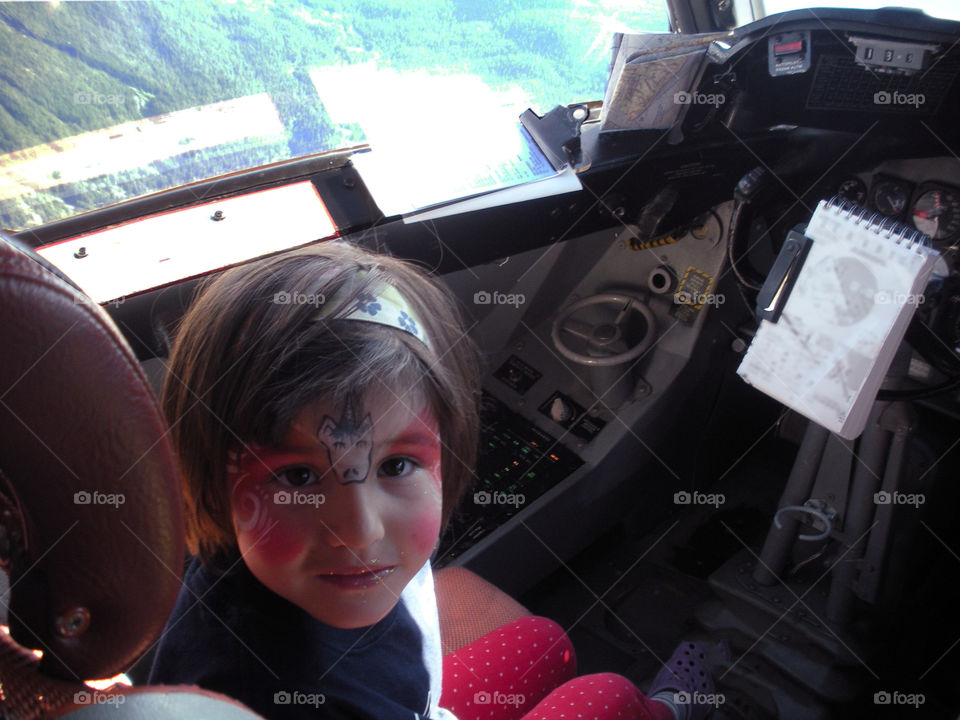 Shot of my daughter sitting in the pilot’s seat of a large transport aircraft on a summer training/ family day flight. She looked nervous because she thought she had to fly the plane but she was happy when the  co-pilot took over. ✈️