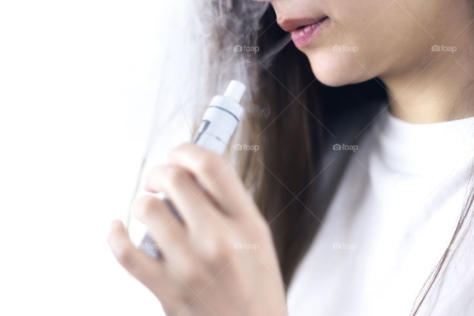 A lady smoking e-cigarettes 