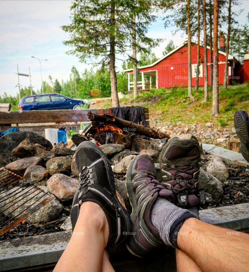 Feet at  a camp fire  