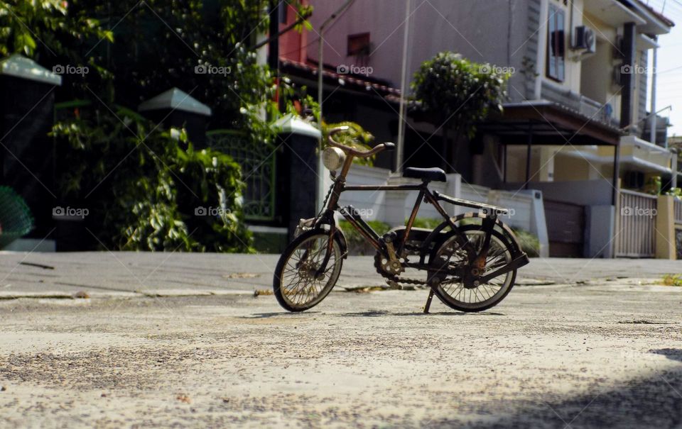 Old toy bike in front of the house