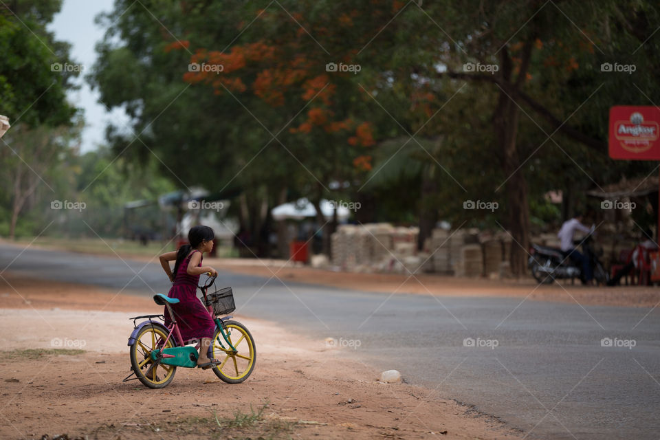 Girl ride bicycle in Countryside of the Siem Reap Cambodia