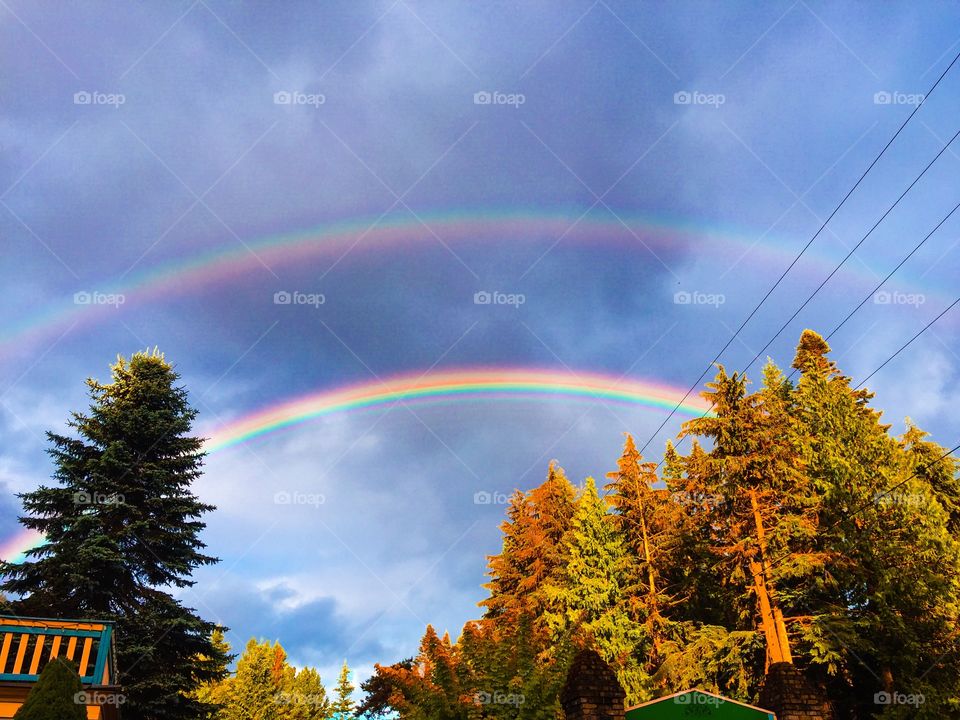 Low angle view of double rainbow