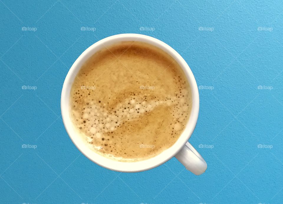 Cup of coffee on blue background