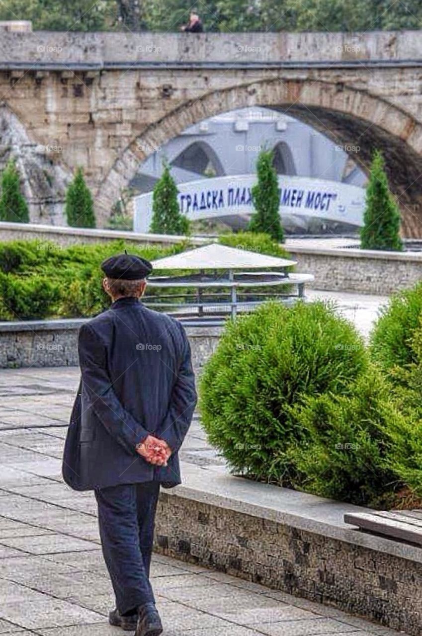 Older man walking towards the Stonebridge