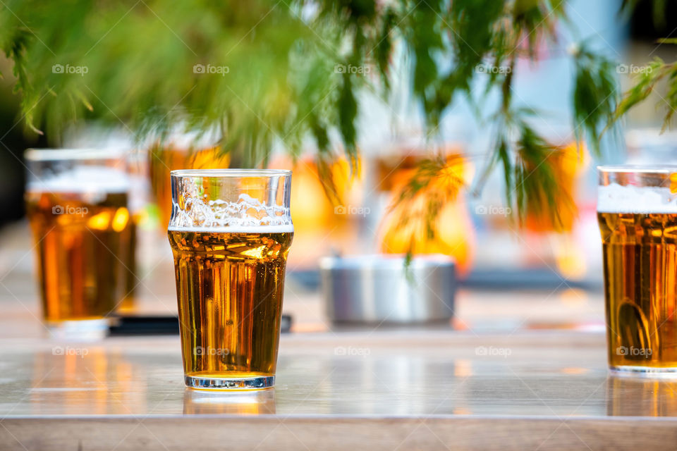 Glasses with beer on the coffee table.