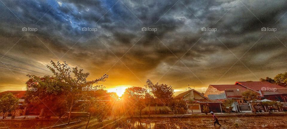 Clouds look dark because they are thicker and denser than normal clouds of a day of mild weather. As a cloud gathers more water droplets and ice crystals, it become thicker and allows less light to pass through it.