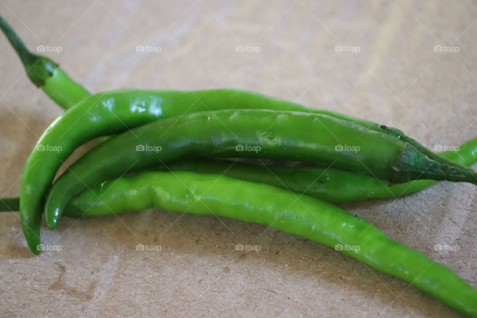 Green pepper or red chilli from the farm, close up or micro fresh beactiy green pepper on the  market texture and background.