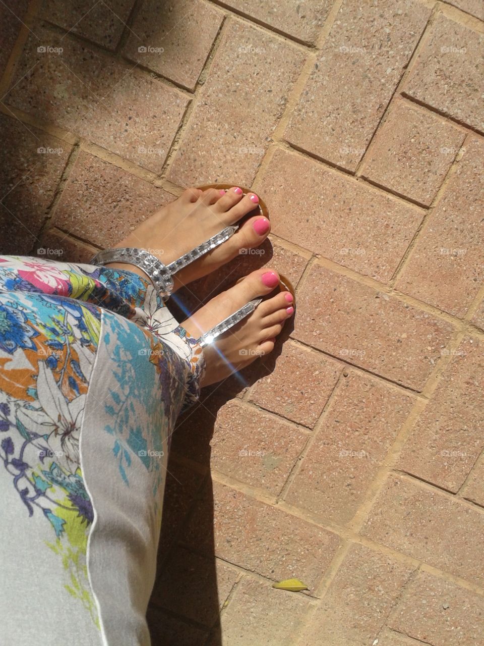 Feet, sandals and pink manicure.
