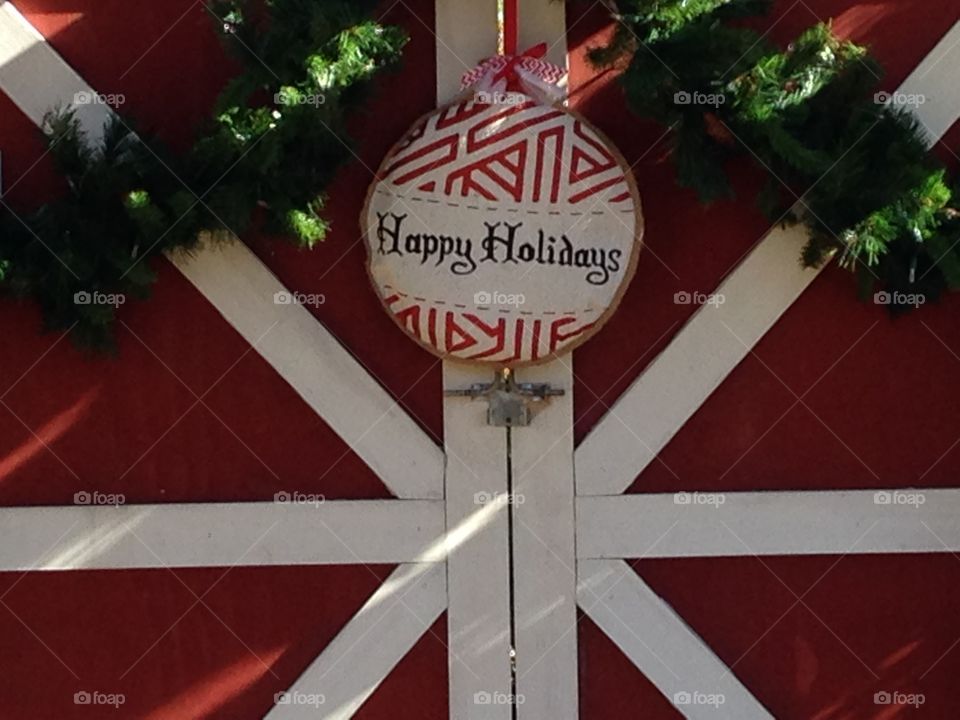 Happy holidays sign on a propped barn door, at the Myriad Gardens in OKC. 