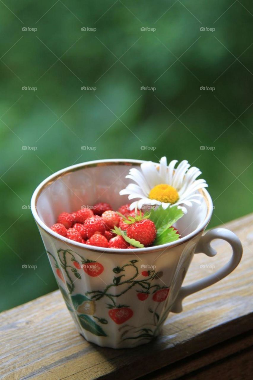 Serve a cup of coffee with flowers and orange slices