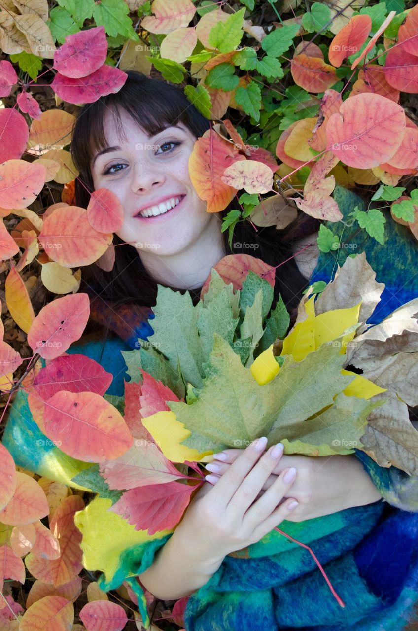 Portrait of a Beautiful Young Girl on Autumn Background